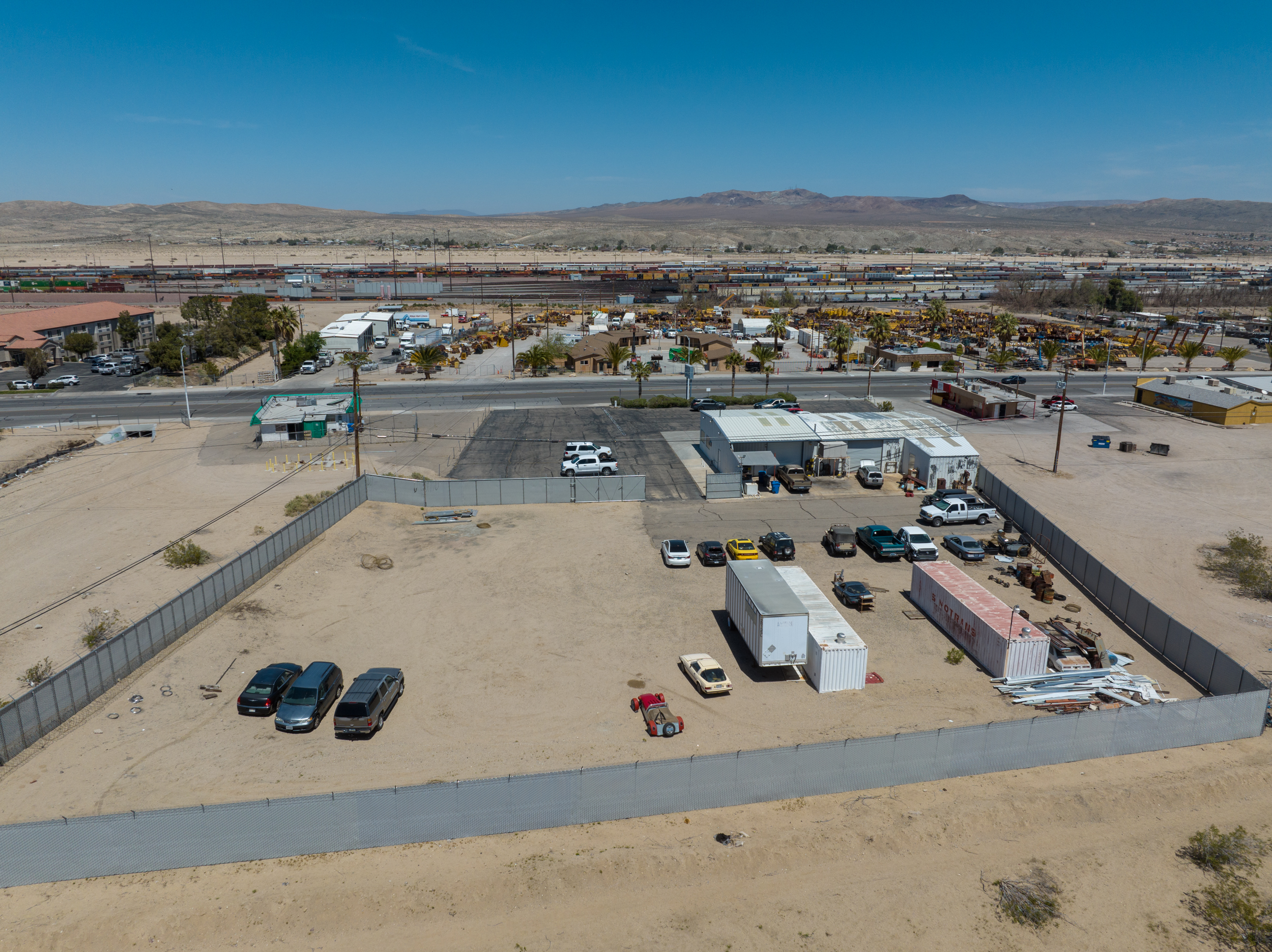 Aerial view showing fenced rear yard and surrounding area at 1720 West Main Street Barstow